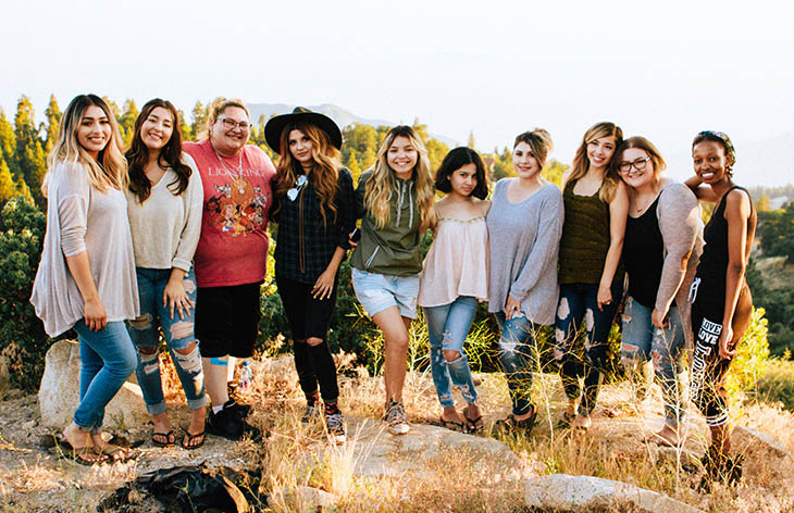 A group of 10 joyful smiling women.